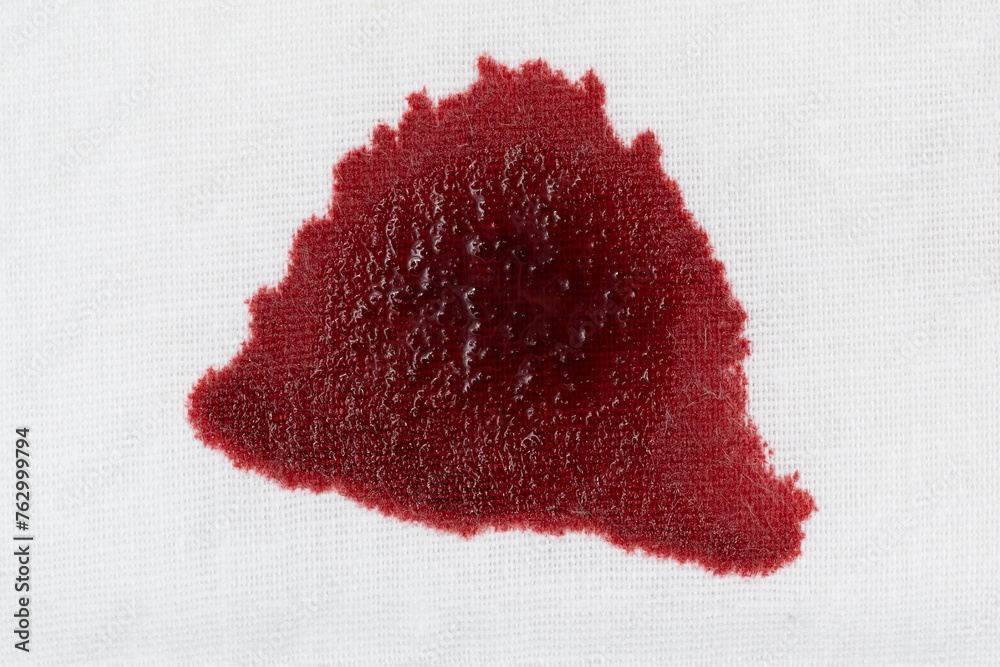 Drops of blood stains on white fabric. blood splatters on clothes. red dripping blood spatters Drops of blood stains on white fabric. blood splatters on clothes. red dripping blood spatters