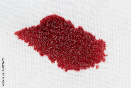 Drops of blood stains on white fabric. blood splatters on clothes. red dripping blood spatters