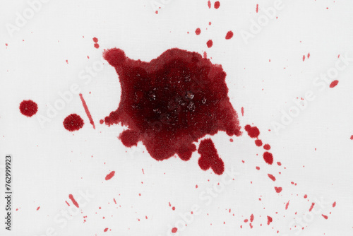 Drops of blood stains on white fabric. blood splatters on clothes. red dripping blood spatters