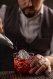 Bartender pouring cocktail at bar