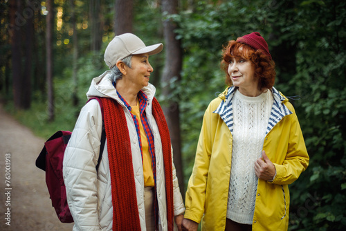 Multiracial old women having a good day in to the wood. Lifestyle and female friendship concept.
