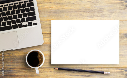 Laptop computer and blank paper,pencil with cup of coffee on wooden table