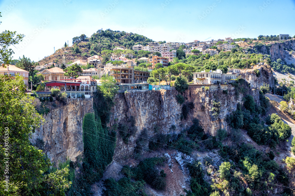 Picturesque houses and restaurants stand on a rocky mountain cliff. Republic of Lebanon