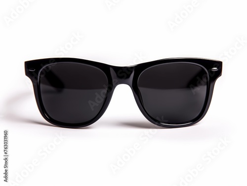 Sleek black sunglasses with a glossy finish isolated on white background, symbolizing fashion and eye protection.