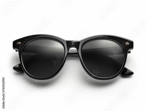 A pair of black classic style sunglasses with tinted lenses against a white background, symbolizing fashion and UV protection.