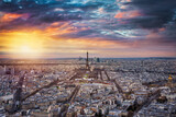 Panoramic view of the urban skyline of Paris, France, with the famous Eiffel Tower in the center during a dramatic sunset