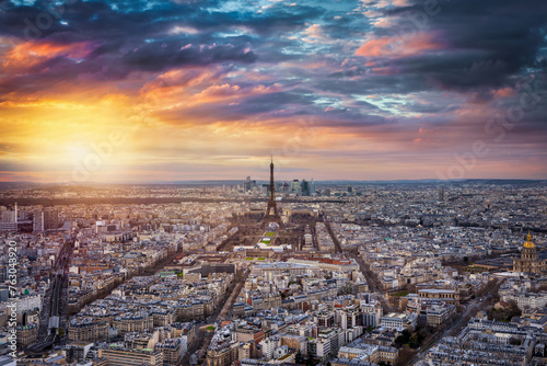 Panoramic view of the urban skyline of Paris, France, with the famous Eiffel Tower in the center during a dramatic sunset