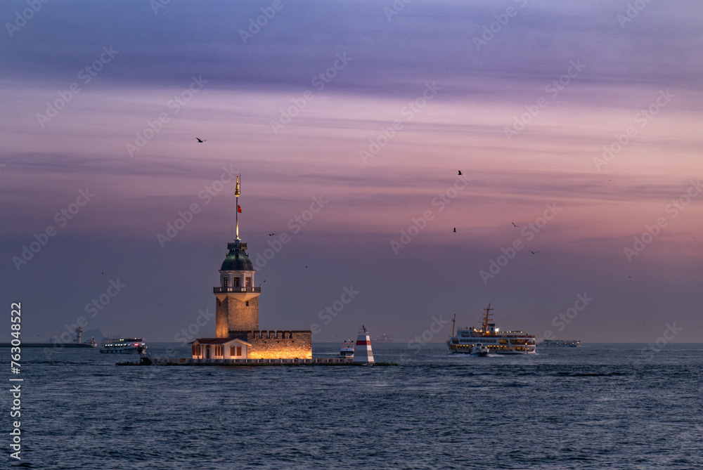 Beautiful sunset over Bosphorus with famous Maiden's Tower (Kiz Kulesi) also known as Leander's Tower, symbol of Istanbul, Turkey. Scenic travel background for wallpaper or guide book