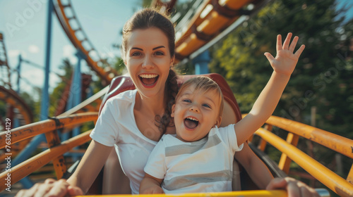 Happy young mother with her cute little boy riding a roller coaster at summer theme park , Generative AI