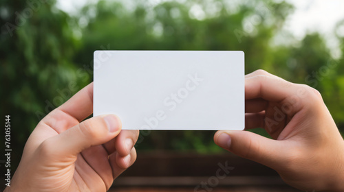 Man hand holding a blank business card