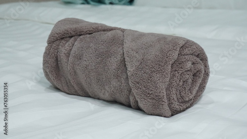 luxury hotel quality shower bath room small exercise face towel in roll shape size on bed product photo shoot display in blue white brown color catalog background menu © perfectloop