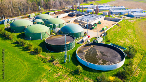 Biogas plant and farm in fields. Renewable energy from biomass. Agriculture prepared for Green Deal. Aerial view to Czech industry. Sustainable development in European Union. 