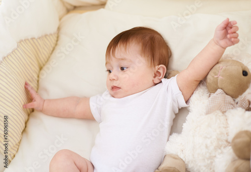 Baby, bedroom and rest with sheep in home, above and healthy with growth, development and playing in morning. Infant, child and newborn with lamb doll, soft toys and relax in nursery at family house