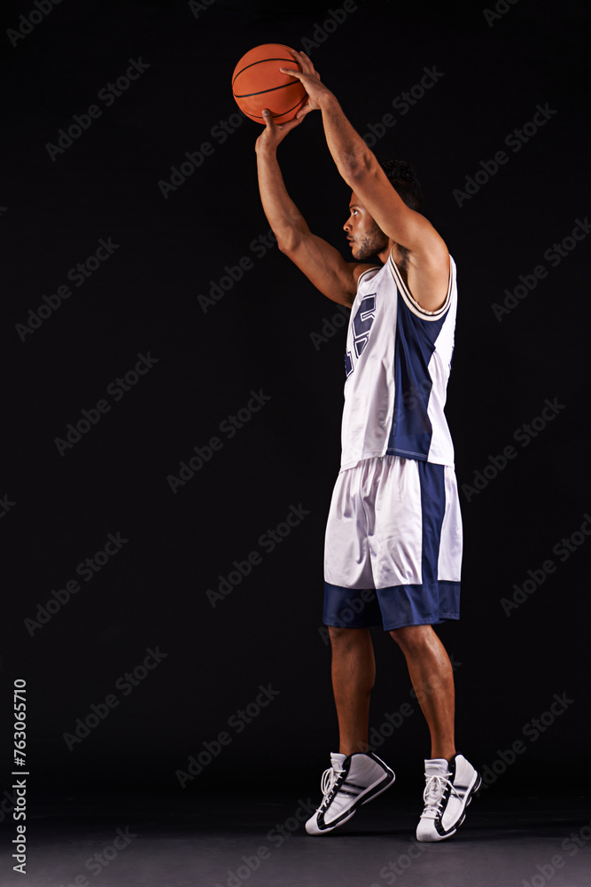 Man, shoot and basketball player in studio as athlete goals for workout competition, training or black background. Male person, playing and exercise champion or professional, fitness or mockup space