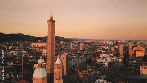 bologna city centre aerial view drone at sunrise flying to asinelli tower landmark with san petronio basilica in the background photo