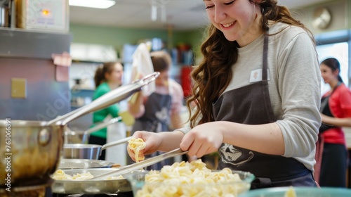 Smiling high school student cooking pasta in home economics class photo