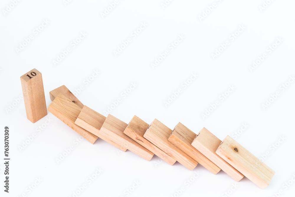 push down the wood pieces dominoes, financial concept plan. Finance concept Financial management in business. push down the wood pieces dominoes, financial concept plan. Finance concept Financial management in business.