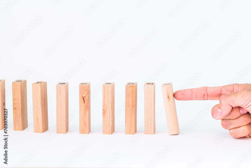 push down the wood pieces dominoes, financial concept plan. Finance concept Financial management in business. push down the wood pieces dominoes, financial concept plan. Finance concept Financial management in business.