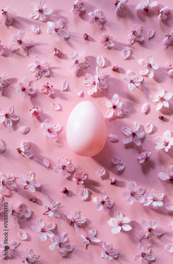 easter egg with cherry flowers on pink background