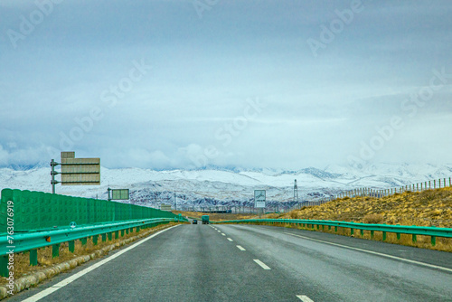 Hainan Mongolian and Tibetan Autonomous Prefecture, Qinghai Province-Train under the snowy mountains