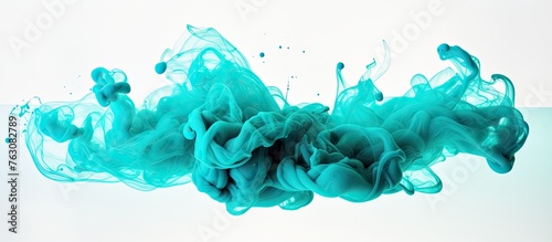 Electric blue liquid splashes in water creating an artistic pattern on a white background, resembling aqua grass. This unique font inspired by fashion accessories features hints of magenta