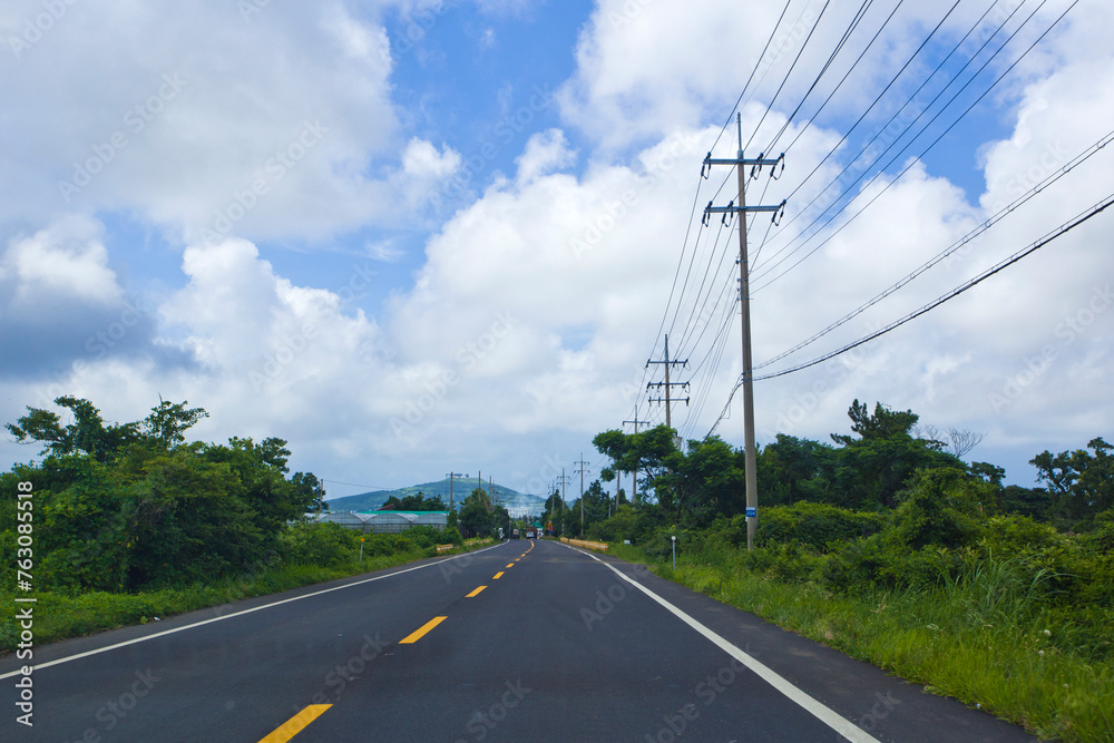 Side view on Jeju Island's main road in summer, South Korea.