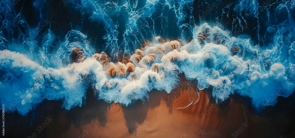 Overhead photo of crashing waves on the shoreline