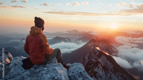 Adventurer Watching Sunrise from Mountain Summit