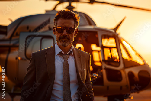 Corporate Executive Arrives in Style: Middle Aged Businessman Touches Down in Private Helicopter for Meeting photo