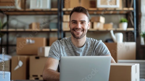 Small business owner is working on a laptop in the warehouse