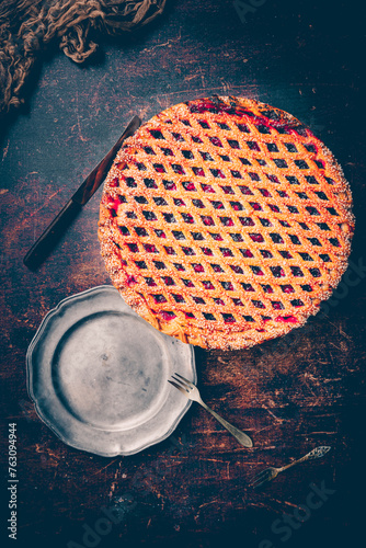 Kersenvlaai. Dutch cherry pie. Cherry pie with dough lattice from Limburg, Netherlands. Handbaked open cherry pie, delicious sweet dessert served on a wooden table. photo