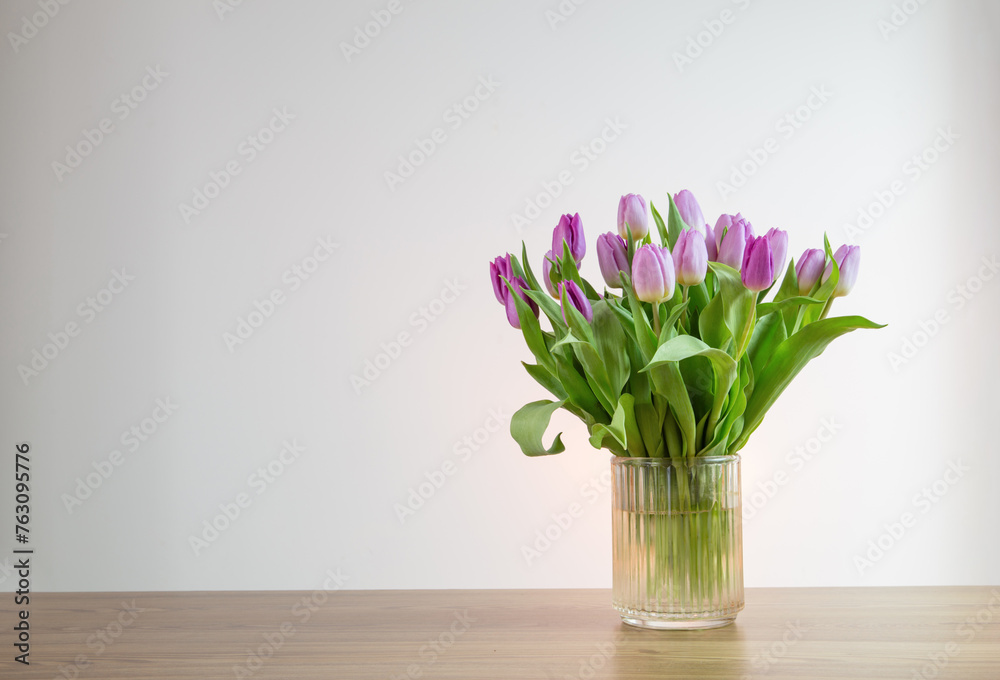 pink tulips in glass vase on white background pink tulips in glass vase on white background