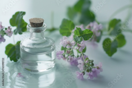 patchouli essential oil in the glass bottle, with fresh patchouli leaves, patchouli oil, aromatic oil, cosmetic product photo