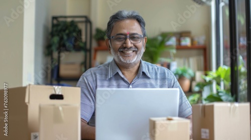 Small business owner is working on a laptop in the warehouse