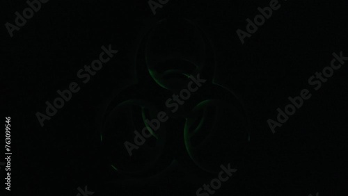 Real TV capture: a flickering green shape on black background, signaling a biohazard danger (biological substances threatening the health of living organisms, human beings). photo