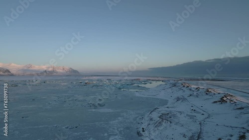 Wallpaper Mural Flying above frozen empty land, snowy countryside during sunset, South Iceland  Torontodigital.ca