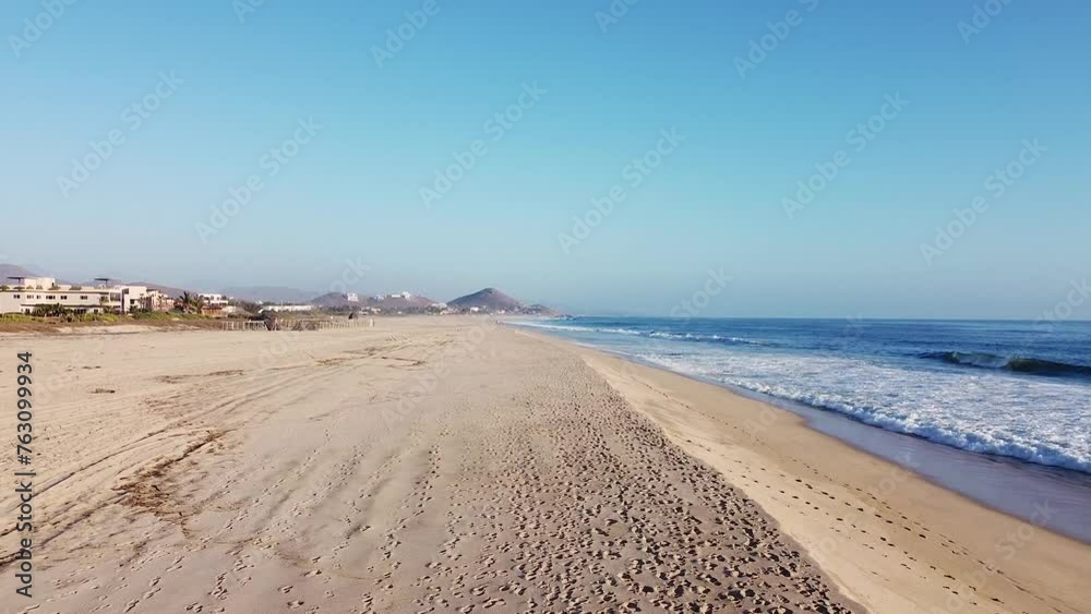 White sand beach and clear blue sky during sunset in El Pescadero, Baja California Sur White sand beach and clear blue sky during sunset in El Pescadero, Baja California Sur