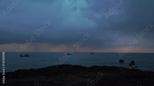 Timelapse shot of the estuary landscape with Vietnamese fishing boats passing back and forth and clouds flying at dawn. Video backgrounds for sensational and epic themes.