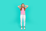 Full length photo of lovely teen lady touch head excited impressed wear trendy print pink garment isolated on cyan color background