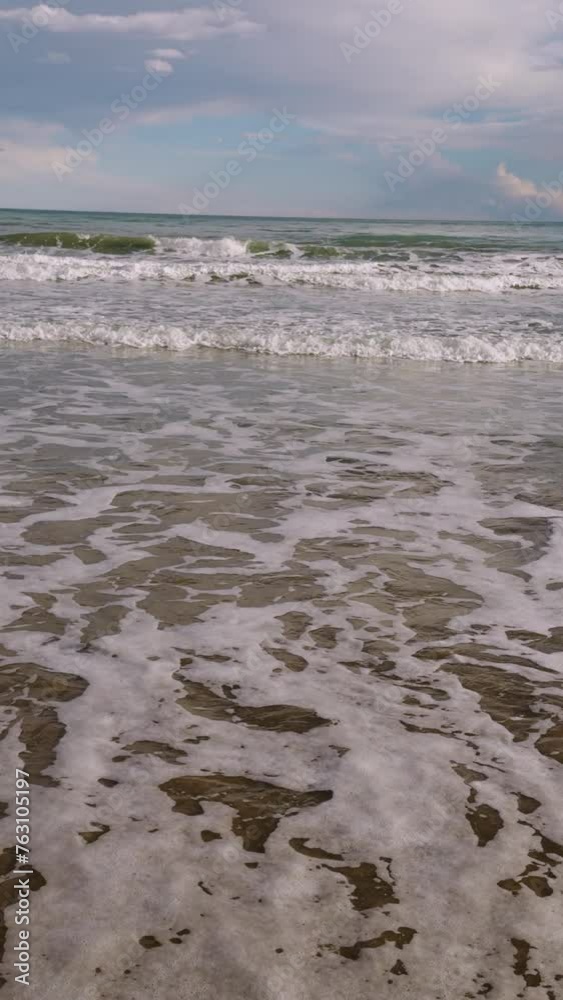 Surf on a sandy beach in the Mediterranean Sea. Beautiful clouds over the horizon in the month of March. Spain Surf on a sandy beach in the Mediterranean Sea. Beautiful clouds over the horizon in the month of March. Spain