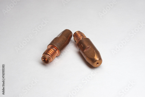 MIG welding contact tips pair. Threaded tail, tapered, shaped