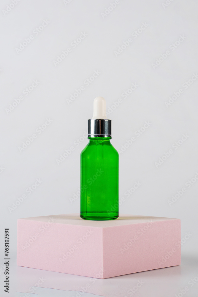 Green glass cosmetic bottle, Skin care or sunscreen cosmetic with stylish props on white background. Green glass cosmetic bottle, Skin care or sunscreen cosmetic with stylish props on white background.