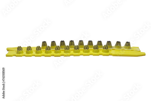 powder actuated tool loads. spent and new cartridges, inserted into pair of yellow strips. on white background photo