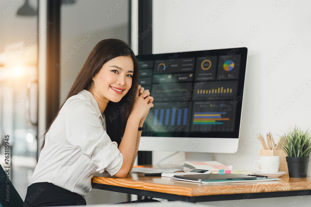 A businesswoman or accountant using laptop to analyze financial investments and business and marketing growth on a data graph. The concepts of accounting, economics, and commercial analysis. A businesswoman or accountant using laptop to analyze financial investments and business and marketing growth on a data graph. The concepts of accounting, economics, and commercial analysis.