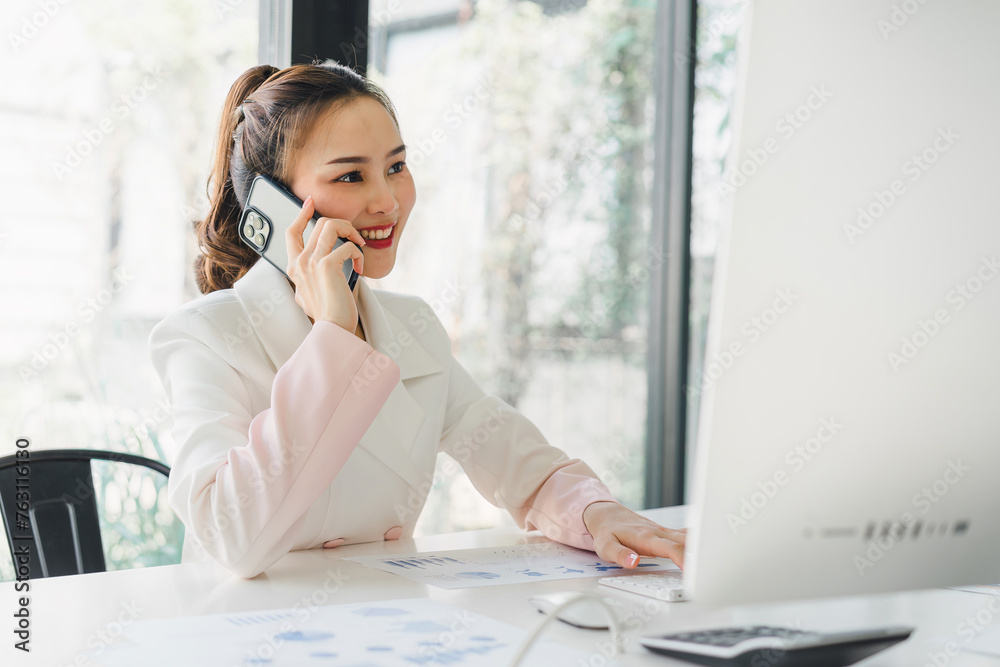 Portrait of beautiful asian secretary woman working with cellphone and desktop in office. Portrait of beautiful asian secretary woman working with cellphone and desktop in office.