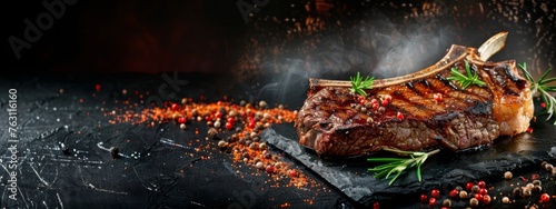 Grilled T-bone steak on stone table. juicy steak rare beef with spices on a black table, banner, menu, recipe, place for text