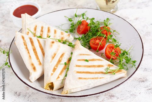 Tasty breakfast with lavash. Mexican cuisine. Trending food with pita bread, cheese, tomatoes and spinach