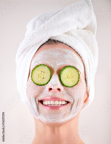 Spa, mask or woman with cucumber facial, skincare in studio with natural detox, smile or cosmetics. Happy model, confidence or face with lotion for anti aging treatment or beauty on white background