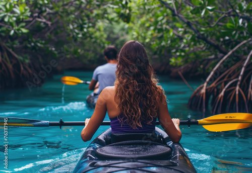 mixed race couple kayaking in the mangroves at sunrise