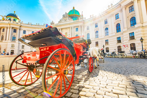 Hofburg palace and horse carriage on sunny Vienna street photo